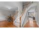 Elegant staircase with wooden handrail and white banisters leading to the upper level, connecting the dining and living areas at 3725 Song Sparrow Dr, Wake Forest, NC 27587