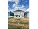 A two-story house with siding, multiple windows and a simple backyard with limited landscaping at 384 Hopewell Branch Ct, Smithfield, NC 27577