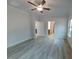 Bright bedroom with wood-look floors, ceiling fan, and natural light at 384 Hopewell Branch Ct, Smithfield, NC 27577