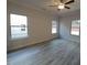 This bedroom features hard surface floors, a ceiling fan, and three windows with trim at 384 Hopewell Branch Ct, Smithfield, NC 27577