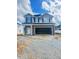 New two-story home featuring stone accents, an attached two-car garage, and a well-manicured lawn at 384 Hopewell Branch Ct, Smithfield, NC 27577