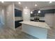 Modern kitchen featuring navy blue cabinets, granite counters, and stainless steel appliances at 384 Hopewell Branch Ct, Smithfield, NC 27577