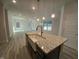 An open-concept kitchen with a view of the living room featuring stainless steel appliances at 384 Hopewell Branch Ct, Smithfield, NC 27577