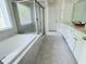 Luxurious bathroom featuring a soaking tub, glass-enclosed shower, and white vanity at 3908 Bostwyck Dr, Fuquay Varina, NC 27526