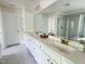 Bright bathroom featuring dual sinks, modern fixtures, and a glass-enclosed shower at 3908 Bostwyck Dr, Fuquay Varina, NC 27526