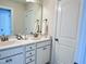 Bathroom featuring double sinks, white cabinets, and bronze fixtures at 3908 Bostwyck Dr, Fuquay Varina, NC 27526