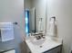 Bathroom featuring a single sink, white cabinets, and bronze fixtures at 3908 Bostwyck Dr, Fuquay Varina, NC 27526