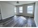 Bedroom with three windows, LVP flooring, and ample natural light at 3908 Bostwyck Dr, Fuquay Varina, NC 27526
