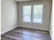 This bedroom has a large window and wood flooring at 3908 Bostwyck Dr, Fuquay Varina, NC 27526