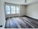 This bedroom has a large window and wood flooring at 3908 Bostwyck Dr, Fuquay Varina, NC 27526