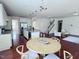 Open-concept space with a large kitchen, hardwood floors, and a dining area with a round table at 3908 Bostwyck Dr, Fuquay Varina, NC 27526