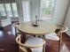 Bright dining area features hardwood floors, a round wooden table, and four chairs at 3908 Bostwyck Dr, Fuquay Varina, NC 27526
