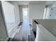 Upstairs hallway featuring luxury vinyl plank flooring, white trim and neutral-toned walls at 3908 Bostwyck Dr, Fuquay Varina, NC 27526