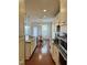 Long kitchen with granite countertops, stainless steel appliances and hardwood floors at 3908 Bostwyck Dr, Fuquay Varina, NC 27526