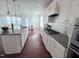 Modern kitchen with stainless steel appliances and hardwood floors at 3908 Bostwyck Dr, Fuquay Varina, NC 27526
