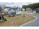 Aerial view of a two-story home nestled in a Gathering-friendly neighborhood with manicured lawns at 401 Club Center Dr, Youngsville, NC 27596