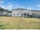 The large backyard showcases a spacious lawn, a privacy fence, and the rear of the house at 401 Club Center Dr, Youngsville, NC 27596