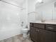 Bathroom with a shower and tub combo, brown vanity, and a white countertop at 401 Club Center Dr, Youngsville, NC 27596
