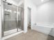 Modern bathroom featuring separate tiled shower, soaking tub, and neutral flooring at 401 Club Center Dr, Youngsville, NC 27596