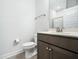 Bathroom with a dark vanity, modern hardware, toilet, and gray tile floor at 401 Club Center Dr, Youngsville, NC 27596