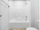 Bathroom showcasing a shower and tub combo with tile floors and gray walls at 401 Club Center Dr, Youngsville, NC 27596