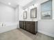 Bathroom with a double sink vanity, tile flooring, and a large mirror at 401 Club Center Dr, Youngsville, NC 27596
