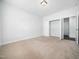 Bedroom with neutral carpet, paint, and a closet with white doors and shelving at 401 Club Center Dr, Youngsville, NC 27596