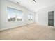 Spacious bedroom featuring neutral carpet, paint, and large windows for ample natural light at 401 Club Center Dr, Youngsville, NC 27596
