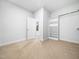Bright bedroom features carpeted floors, built-in shelves and a view into an adjoining room at 401 Club Center Dr, Youngsville, NC 27596