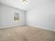 Bright bedroom features neutral carpet and paint with a window letting in natural light at 401 Club Center Dr, Youngsville, NC 27596