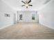 Spacious bedroom with neutral carpet, bright windows, ceiling fan and modern fixtures at 401 Club Center Dr, Youngsville, NC 27596