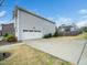 Home's side exterior featuring a two-car garage and a long driveway at 401 Club Center Dr, Youngsville, NC 27596