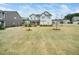 Attractive two-story home with a red front door, landscaping and sprawling front yard at 401 Club Center Dr, Youngsville, NC 27596
