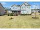 Charming two-story home features a symmetrical facade, gray siding, and a well-manicured lawn at 401 Club Center Dr, Youngsville, NC 27596