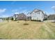 View of a two-story house featuring light gray siding, a manicured lawn, and well-maintained landscaping at 401 Club Center Dr, Youngsville, NC 27596