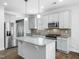 Well-lit kitchen featuring stainless steel appliances, island, and gray cabinets at 401 Club Center Dr, Youngsville, NC 27596