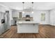 Modern kitchen with an island, stainless steel appliances and wood floors at 401 Club Center Dr, Youngsville, NC 27596