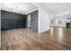 Living room featuring hardwood floors, wainscoting, and a fireplace, with views into other rooms at 401 Club Center Dr, Youngsville, NC 27596