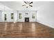 Spacious living room featuring wood floors, ceiling fan and fireplace at 401 Club Center Dr, Youngsville, NC 27596