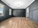 Spacious living room featuring hardwood floors, wainscoting, and an open floor plan at 401 Club Center Dr, Youngsville, NC 27596