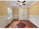 Bedroom with hardwood floors, ceiling fan, closet, and natural light from the window at 408 Teal Lake Dr, Holly Springs, NC 27540