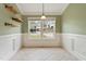 Bright dining area with wainscoting and tile floors, perfect for intimate meals and gatherings at 408 Teal Lake Dr, Holly Springs, NC 27540