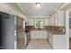 Updated kitchen with stainless steel appliances, granite countertops, and mosaic tile backsplash at 408 Teal Lake Dr, Holly Springs, NC 27540