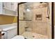 Modern bathroom featuring a tiled shower with glass door, niche, and updated fixtures at 408 Teal Lake Dr, Holly Springs, NC 27540