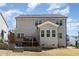 This home features a patio, deck, a gray back exterior, and manicured lawn at 420 Cahors Trl, Holly Springs, NC 27540