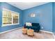 The blue bedroom features a bright window, cozy furnishings, and serene decor at 420 Cahors Trl, Holly Springs, NC 27540