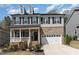 Charming two-story home features a brick and siding exterior, dormer windows, and a welcoming front porch at 420 Cahors Trl, Holly Springs, NC 27540