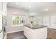 Bright kitchen featuring granite countertops, stainless steel appliances, and access to dining area at 420 Cahors Trl, Holly Springs, NC 27540