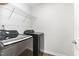 This laundry room has gray front loading machines and wire shelving at 420 Cahors Trl, Holly Springs, NC 27540