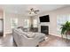 Comfortable living room featuring a fireplace, ceiling fan, and neutral decor at 420 Cahors Trl, Holly Springs, NC 27540